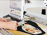 Embroidery machine stitching a portrait